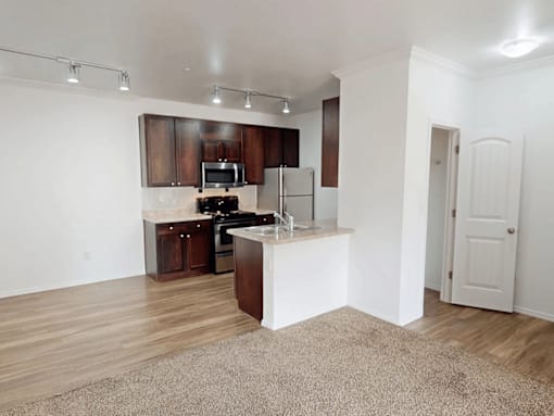 A kitchen with wooden cabinets and a white island.