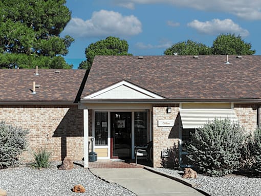 A small building with a brown roof and a sign that says