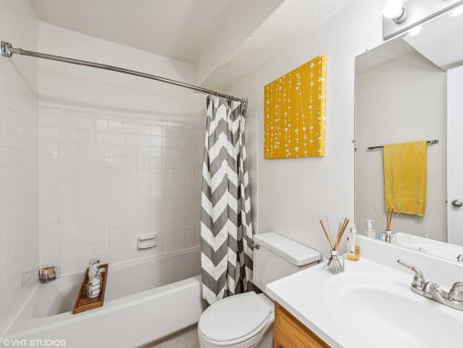 a white bathroom with a shower curtain and a sink