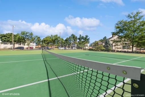 a tennis court with a net on it at apartment community