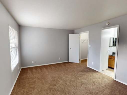A room with carpeted floor and white walls.