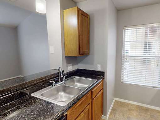 A kitchen with a granite countertop and a sink.