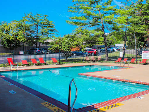 A pool with a diving board and a yellow caution tape on the ground.