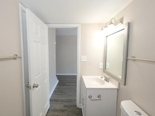 A bathroom with a white sink and toilet.