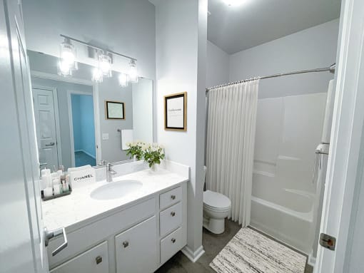 full bathroom with tub and large vanity space