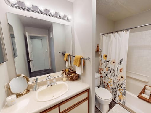 A bathroom with a white sink and a white toilet.