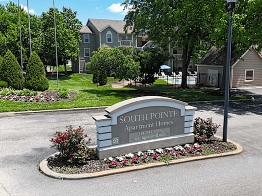 A sign for Southpointe Apartment Homes is in front of a building.