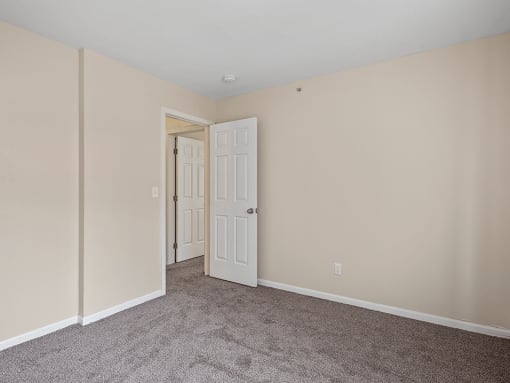a bedroom with beige walls and carpet