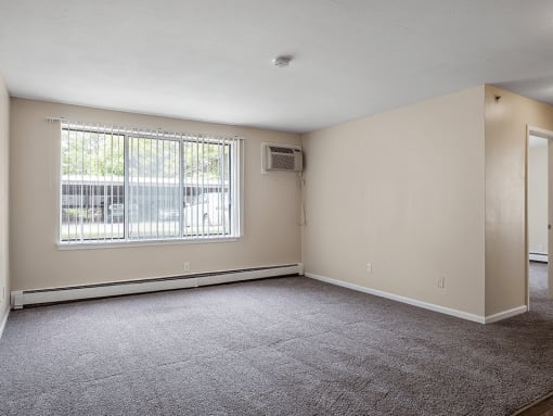 an empty bedroom with a large window