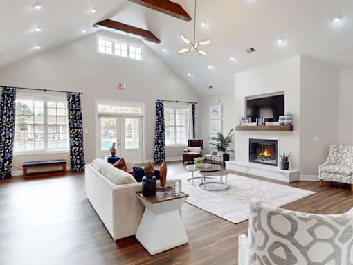 A spacious living room with a fireplace and a ceiling fan.