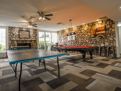 a game room with a pool table and ping pong