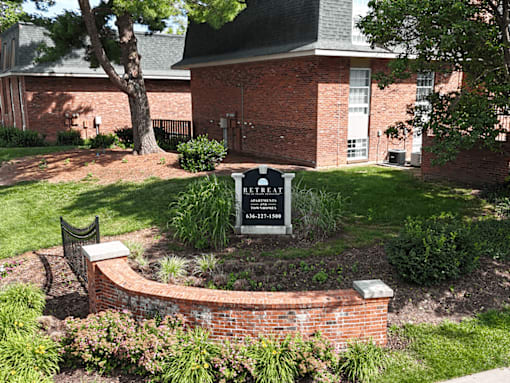 A sign in front of a brick building reads "Breakfast.".