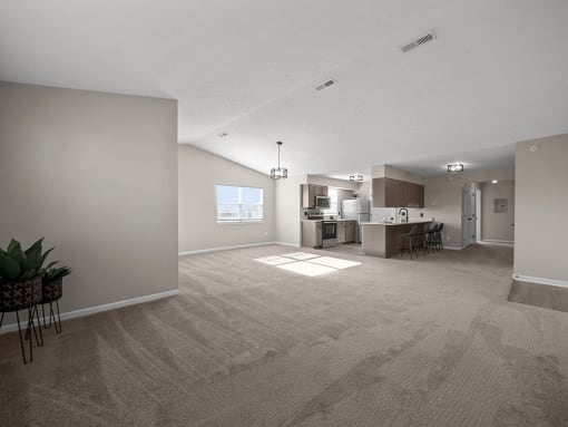 the living room and kitchen of an apartment