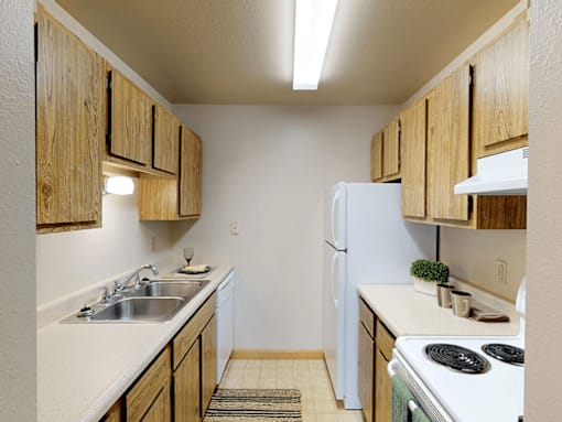 A kitchen with wooden cabinets and a white refrigerator.