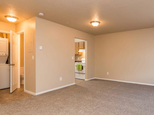 A kitchen area with a refrigerator and a small kitchenette.