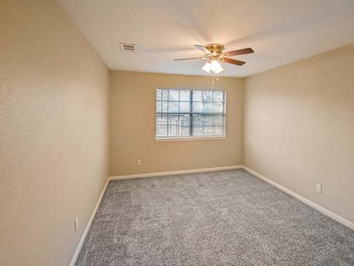 bedroom with a ceiling fan and a window