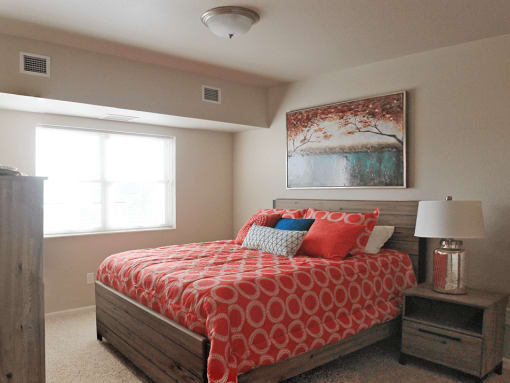 a bedroom with a bed and two windows