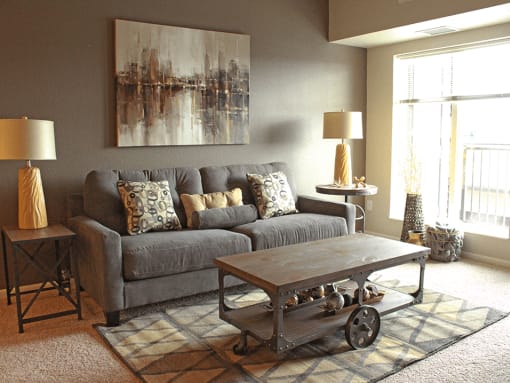 a living room with a gray couch and a coffee table