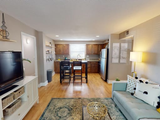 an open living room and kitchen with a table and chairs