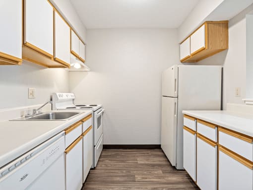 apartment kitchen with white appliances and a refrigerator