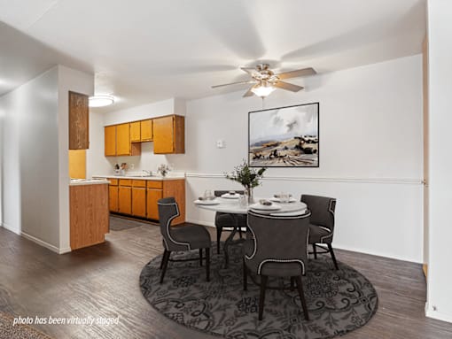 A modern kitchen with a dining table set for four.