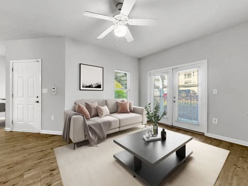 a living room with a couch and a ceiling fan