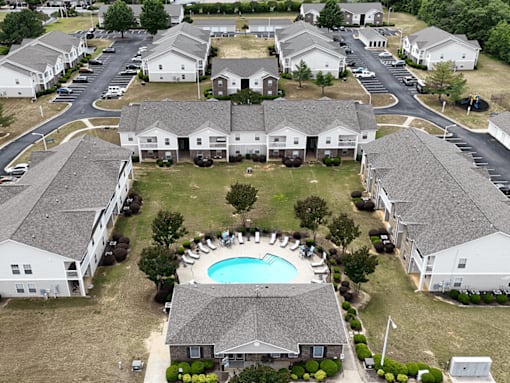 A large white building with a pool in the middle of it.
