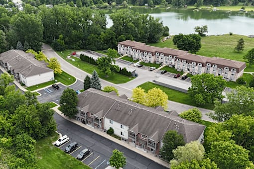 A bird's eye view of a residential area with a lake in the background.