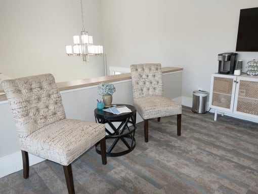 a leasing office with two chairs and a table