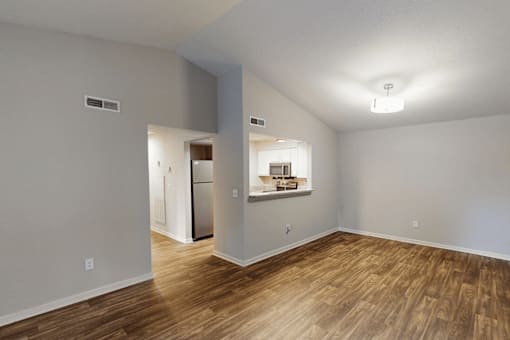 A room with wood flooring and a white ceiling.