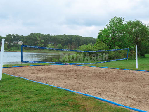 a volleyball court on a wandy beach next to a lake