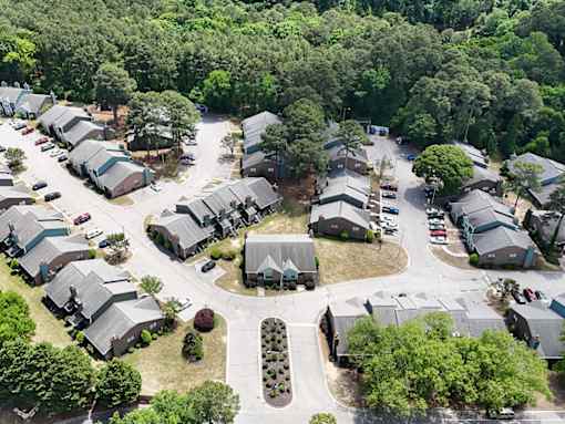 A bird's eye view of a residential area with houses and cars.