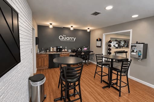 A modern dining area with a black table and chairs.
