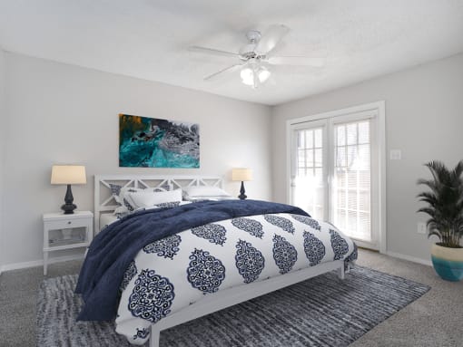 a bedroom with a bed and a ceiling fan