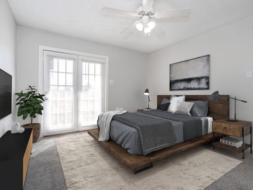 a bedroom with a bed and a ceiling fan