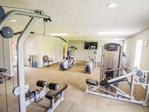 A well equipped gym with a variety of exercise equipment.