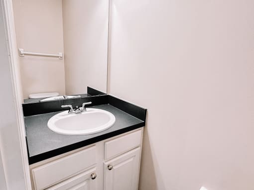 a small bathroom with a sink and a mirror