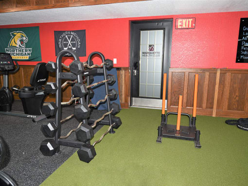 a room with a row of weights and a cart in it