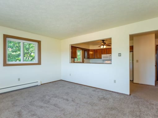 an empty living room with a large window