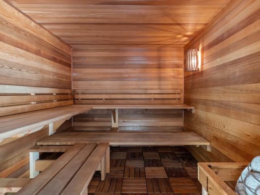 a wooden sauna with benches on the floor