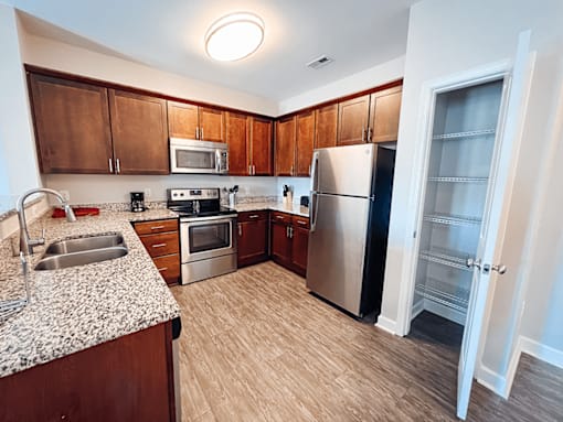 A kitchen with wooden cabinets and a refrigerator.