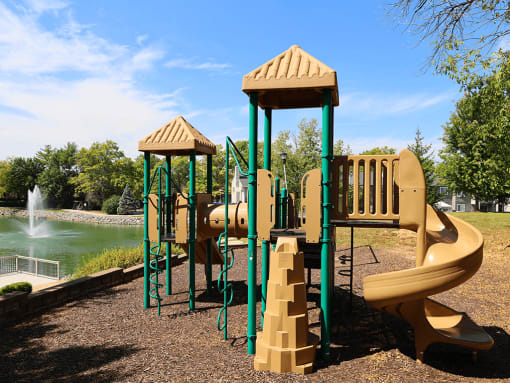 a playground with a swing set and slides