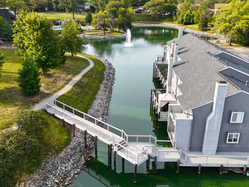 bridge over waterway connecting apartment buildings
