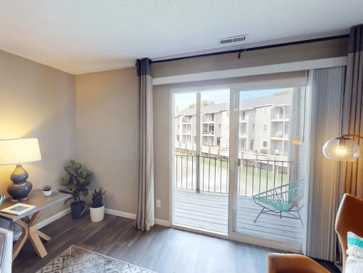apartment living room with sliding glass doors to a balcony