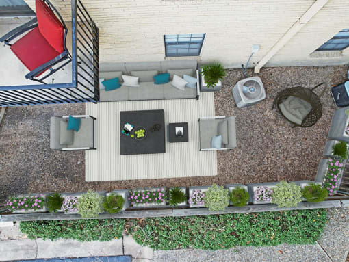 a birds eye view of a patio with furniture and plants
