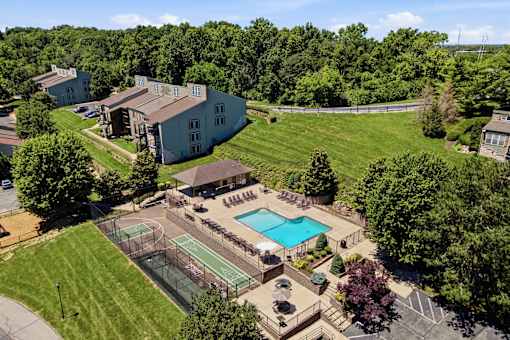 A large building with a pool in front of it.