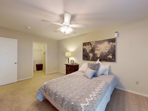 a bedroom with a ceiling fan