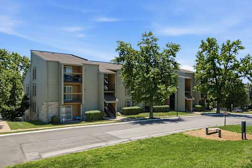 Apartment complex with a green lawn in front.