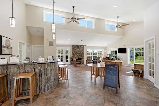 A kitchen with a bar and a dining table.