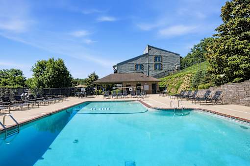A large swimming pool with a building in the background.